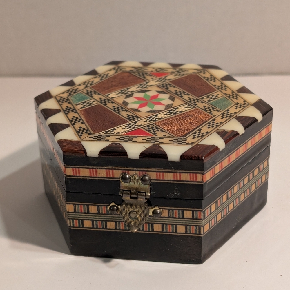 A vintage, handmade, octagonal trinket box featuring intricate Inlay.